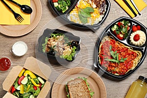 Lunchboxes with different meals on table, flat lay. Healthy food delivery