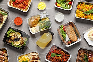 Lunchboxes on grey table, flat lay. Healthy food delivery