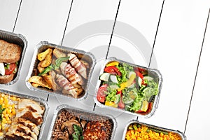 Lunchboxes on white wooden table. Healthy food delivery