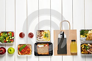 Lunchboxes on white wooden table. Healthy food delivery