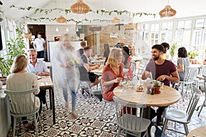 Lunchtime customers eating at a busy restaurant