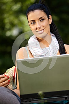 Lunchtime portrait of young woman with laptop