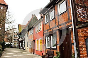 Luneburg, Germany - 10.12.2017: Traditional facades of medieval houses. Decorated for Christmas doors and windows