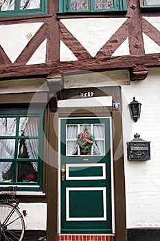 Luneburg, Germany - 10.12.2017: Traditional facades of medieval houses. Decorated for Christmas doors and windows