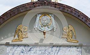 Lunette on Orthodox church with face of Jesus and two angels