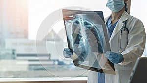 Lung disease, covid-19, asthma or bone cancer illness with doctor diagnosing patientâ€™s health with radiological chest x-ray film