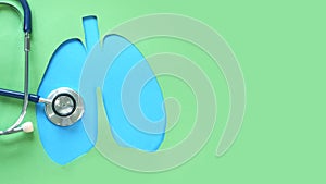 Lung health therapy medical concept . silhouette of the blue lungs and a stethoscope on a green background. concept of