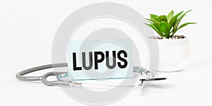 LUPUS word on notebook,stethoscope and green plant