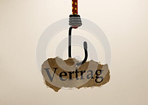 Luring customers and unfair adhesion contract concept: isolated piece of brown old scrap paper hanging on hook, white background