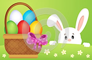 Lurking Easter bunny by basket with eggs