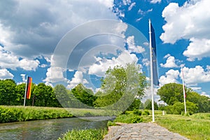 Lusatian Neisse with flags of Germany, Europe Union and Poland in Sudetes on border of three countries