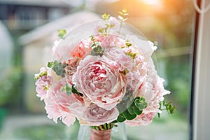 Lush bridal bouquet of pale pink flowers, close-up, blurred background. Wedding concept, postcard