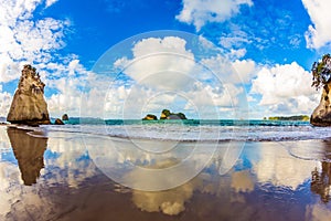 The lush clouds are reflected in sand