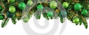 Lush fir twigs and green baubles on white