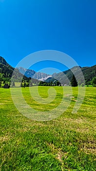 Bodental - Lush green alpine meadow of Maerchenwiese with panoramic view of Karawanks photo