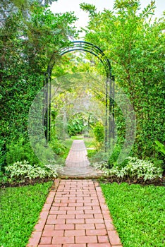 Lush green garden with wrought iron arbor