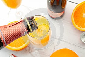 Lush mix drinks, summer alcoholic beverages and refreshing brunch mimosa cocktail concept with top view of orange fruits and photo