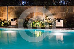 Lush pool lighting in backyard for luxury swimming pool design c