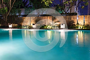 Lush pool lighting in backyard for luxury swimming pool design c