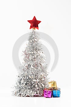 Lush silver Christmas tree decorated with a bright red star on the top