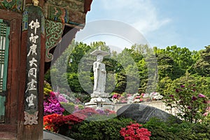 Lush vegetation and Buddha statue at the Bongeunsa Temple in Seoul