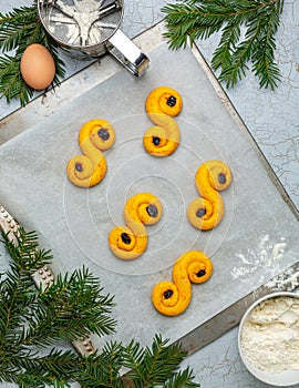 Lussekatt saffron buns on the baking sheet