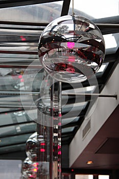 Lusters with a globe shape were suspended from the ceiling of a restaurant in Paris (France)