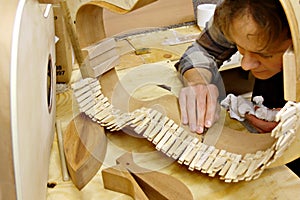 Luthier Building Guitar in Workshop photo