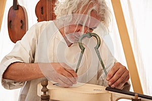 The luthier builds a medieval stringed instrument