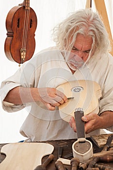 The luthier builds a medieval stringed instrument photo