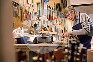 Luthier carving the body of a lute