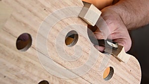 Luthier with a chisel working in the structure of a new violin