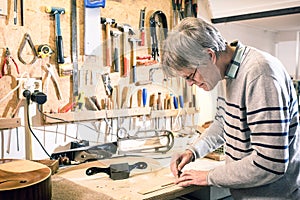 Luthier drawing the outline of a lute piece