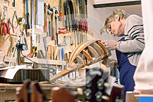 Luthier inspecting his halfway finished lute