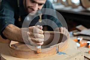 Luthier Inspects Kerfin Lining on Guitar Body