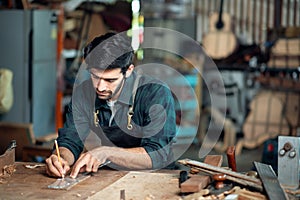 Luthier making a peghead of classical guitar