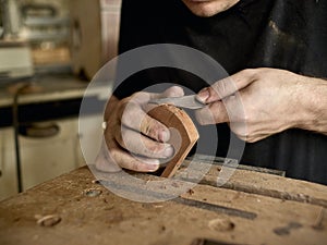 Luthier modifies the head of classical guitar.
