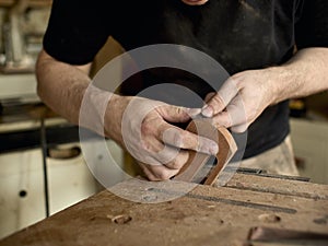 Luthier modifies the head of classical guitar.