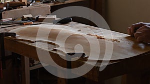 Luthier sanding the cover of a new violoncello