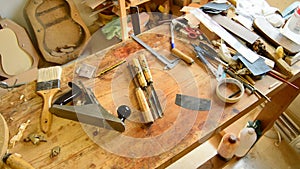 Luthier sanding a guitar, pan