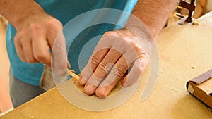 Luthier sanding a guitar piece