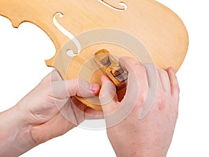 Luthier using small hand plane photo