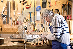 Luthier working at his lute on the workbench