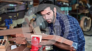 Luthier is working on the neck of a classical guitar