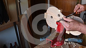 Luthier working in the structure of a new viola or violin