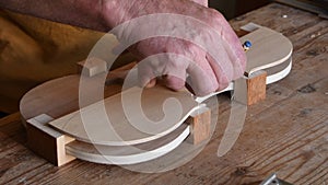 Luthier working in the structure of a new violin