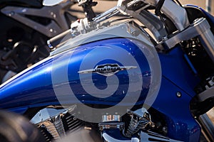 Closeup of blue tank of suzuki intruder motorbike parked in the street