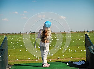 Luttle girl swinging golf club