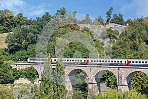 Luxembourg city with historic bridge near Kirchberg and passing train