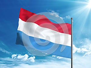 Luxembourg flag waving in the blue sky